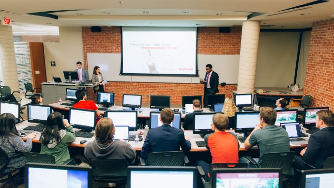 Back of the classroom view looking at professor giving lecture