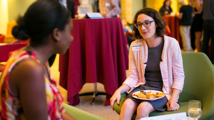 two women talking while eating