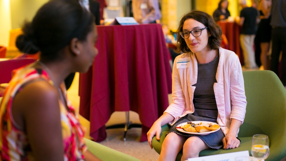 two women talking while eating