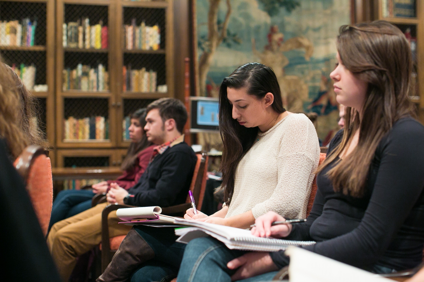 Students sitting in class room listening to lecture