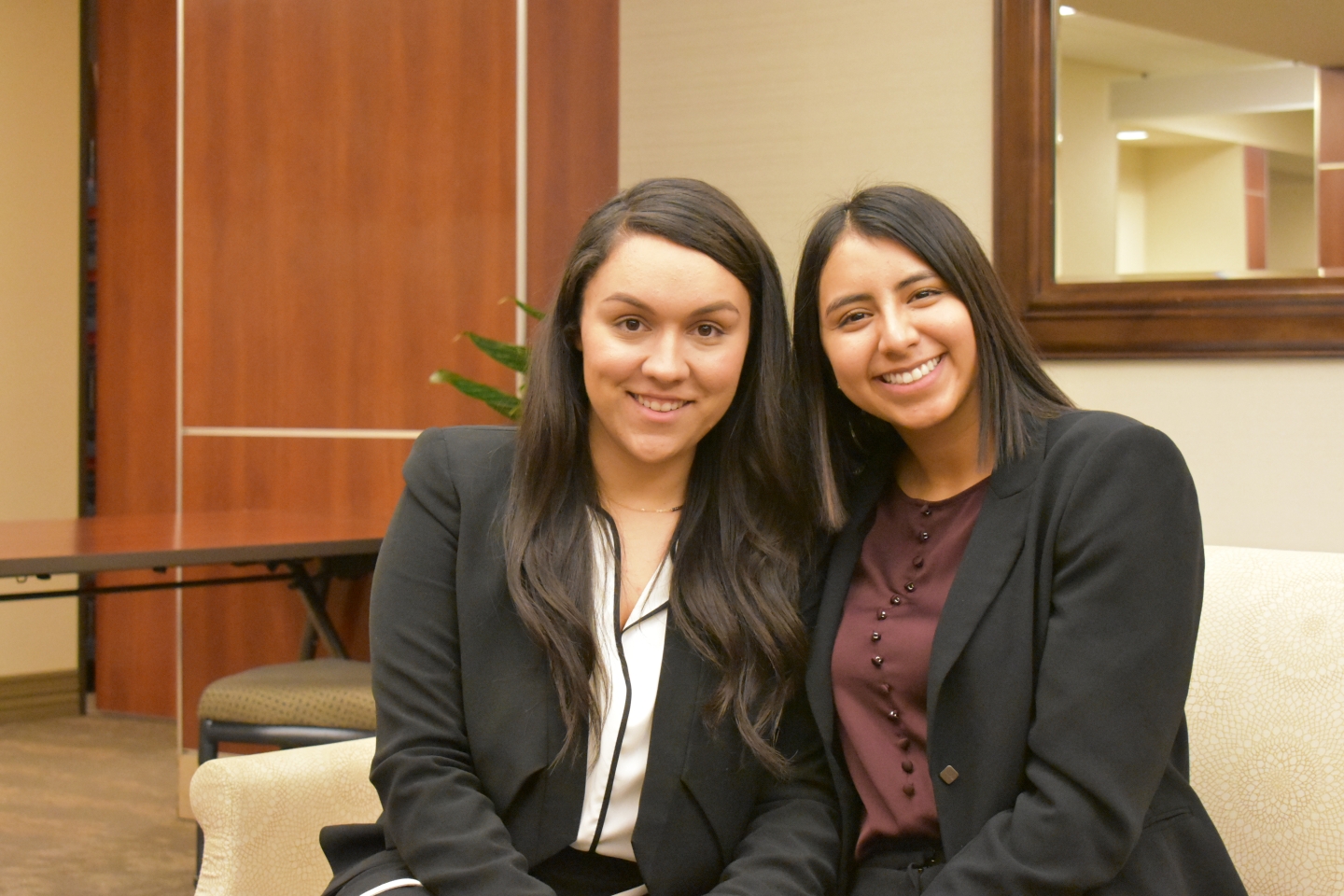 Students Gabbie and Sabrina sit together at a local hospital. 
