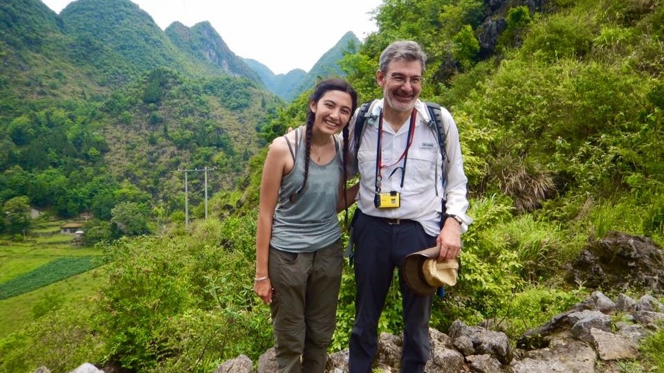 Geology professor stands with a student in valley while studying abroad in China