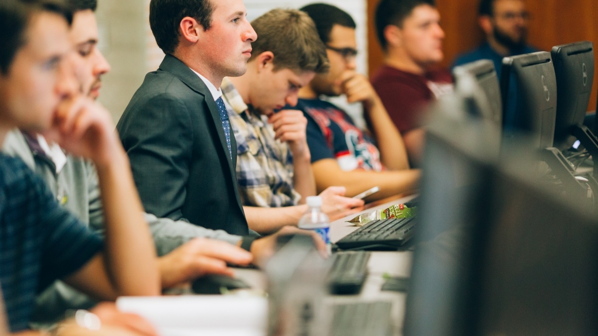 Students sitting at computers listening to lecture