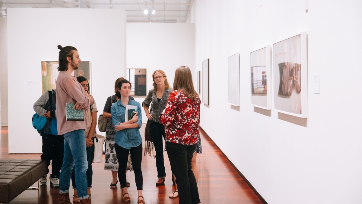 Group Gathered in Front of an Art Exhibit