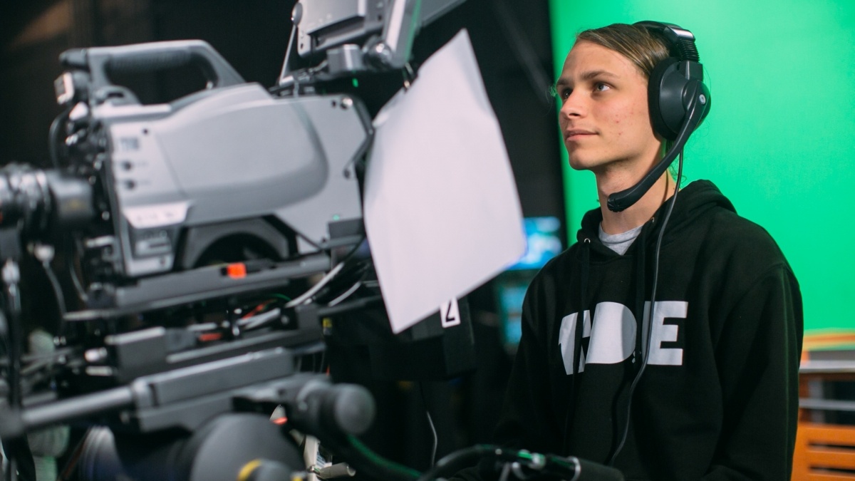 Trinity student with Tiger TV operates a video camera