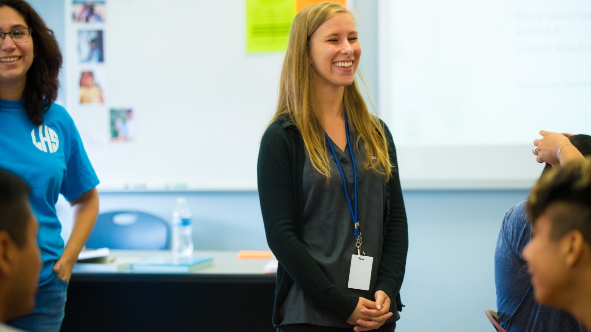 Trinity students standing in front of classroom