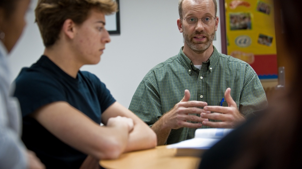Professor talking to a group of students