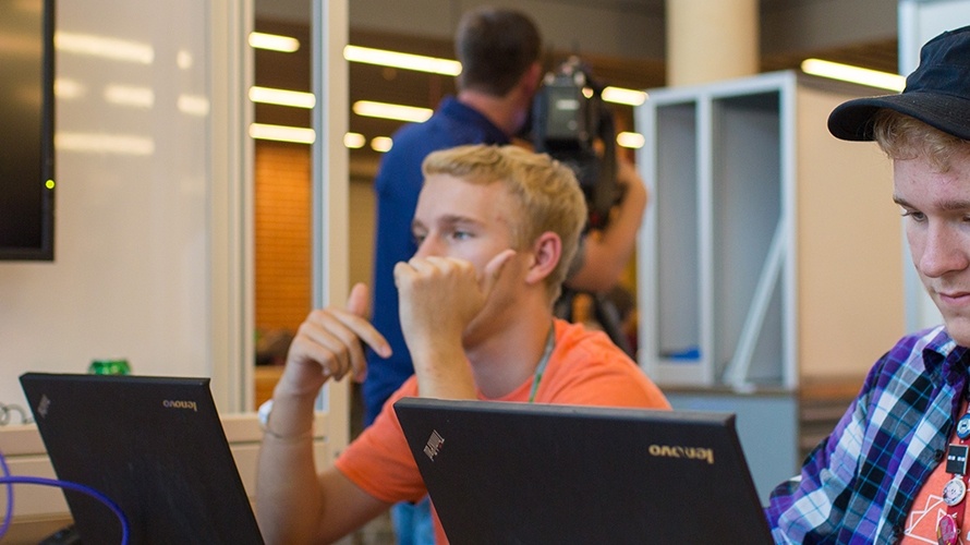 two students work on their laptops 