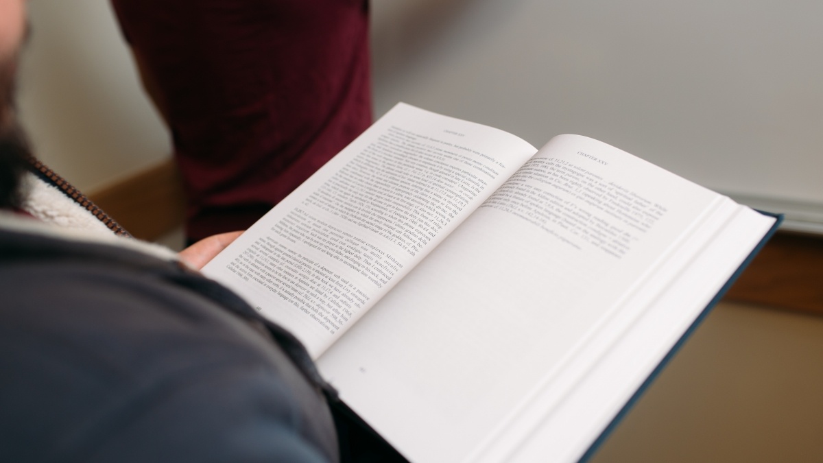 open book on a student's lap