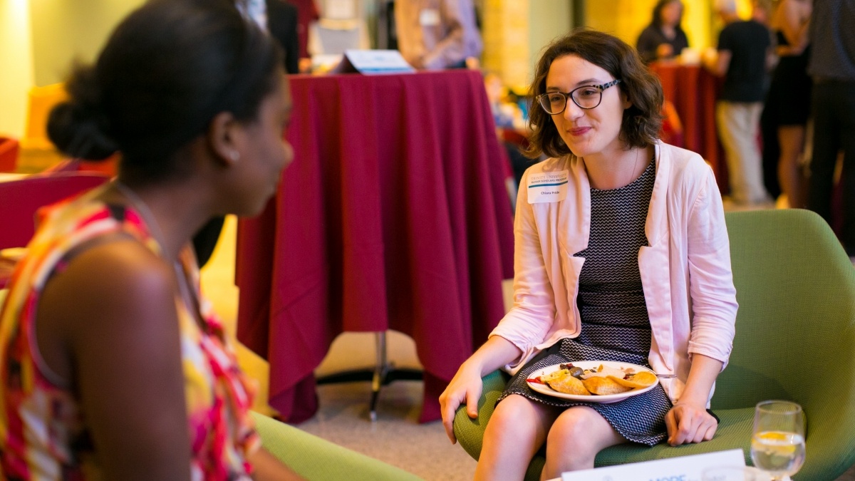 two women talking while eating
