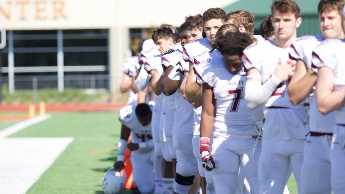 A Trinity football player kneeling for social justice