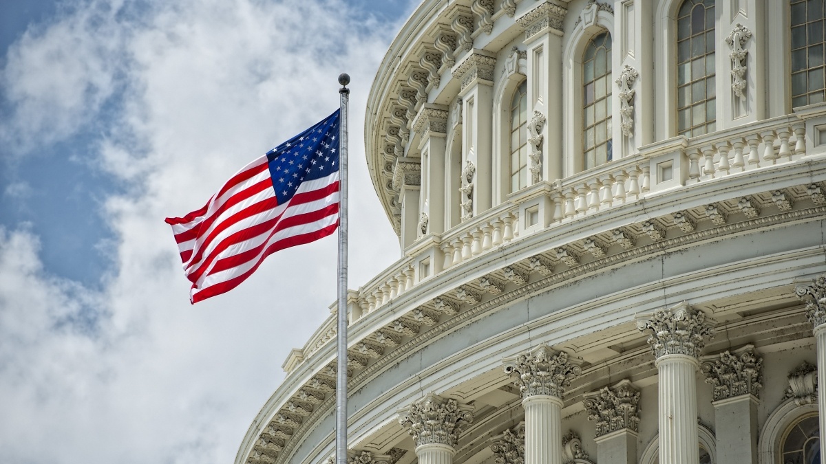 US Flag in front of the capitol
