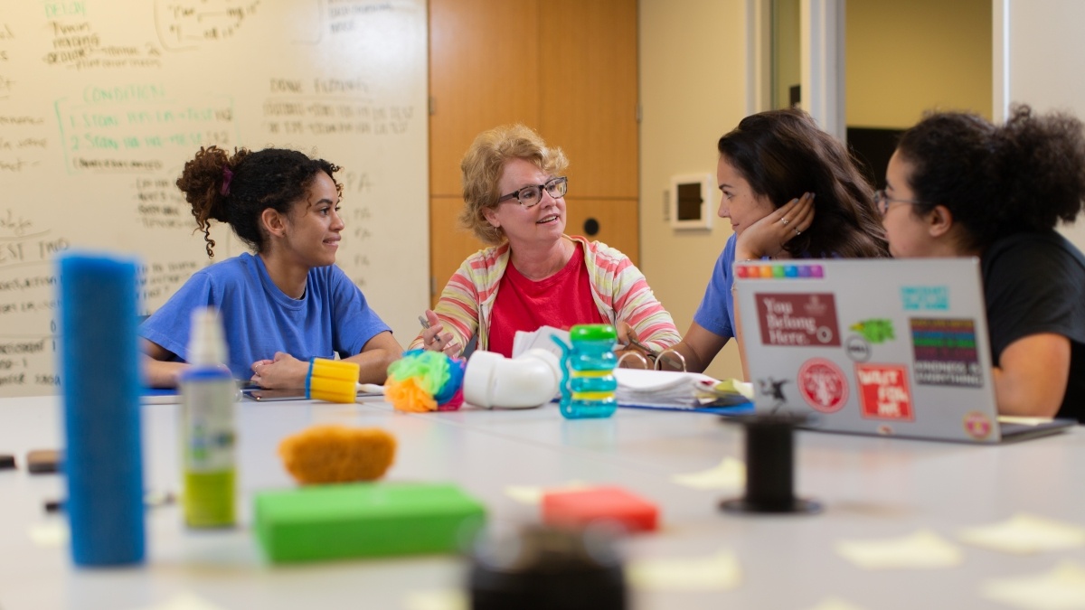 group of people sitting around a table with manipulatives (objects to be manipulated)